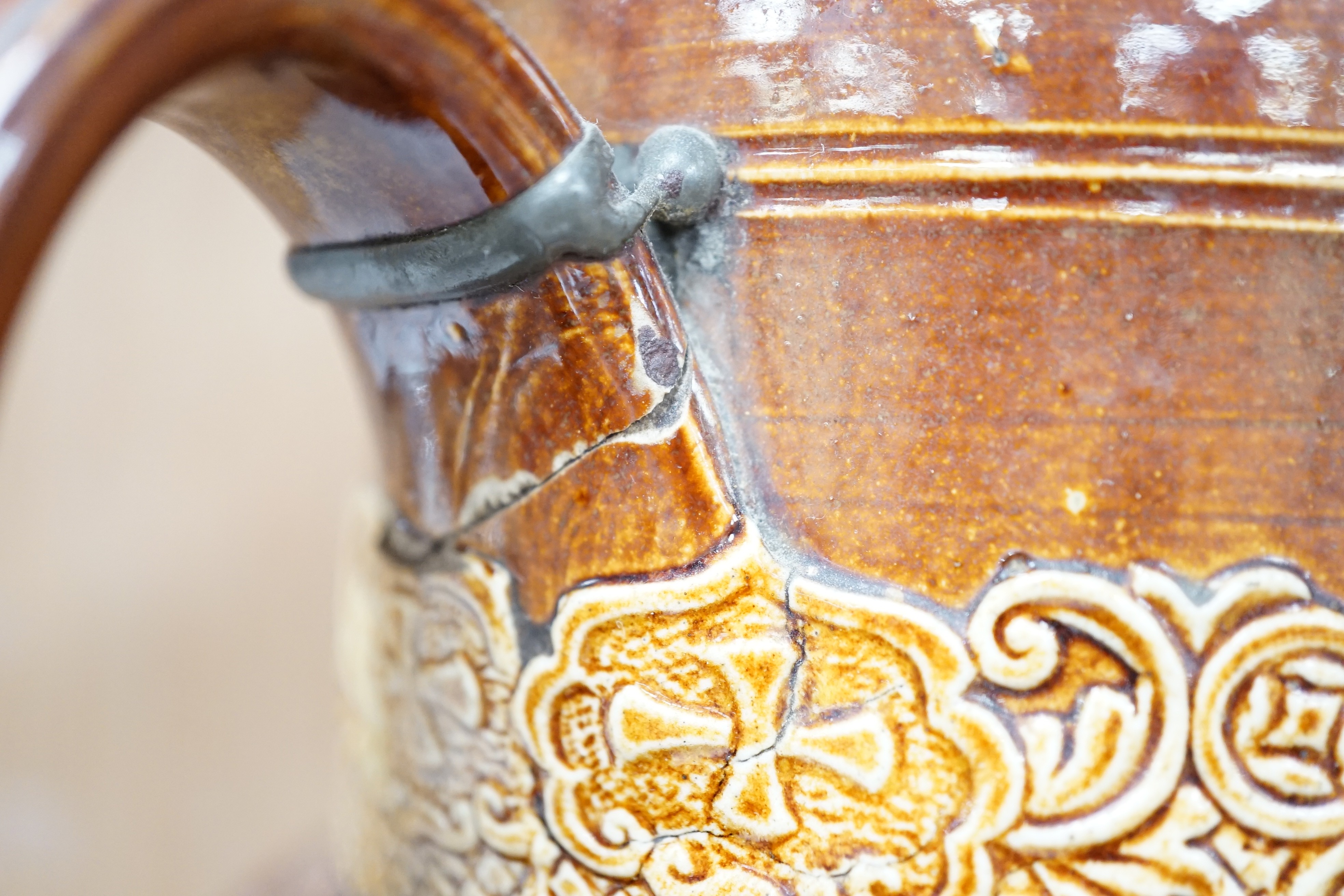 A Victorian solid agate ware pottery jug, a similar bowl and pair of miniature jugs, an unusual Doulton Lambeth stoneware jug and a small relief-moulded teapot, Doulton jug, 19cms high